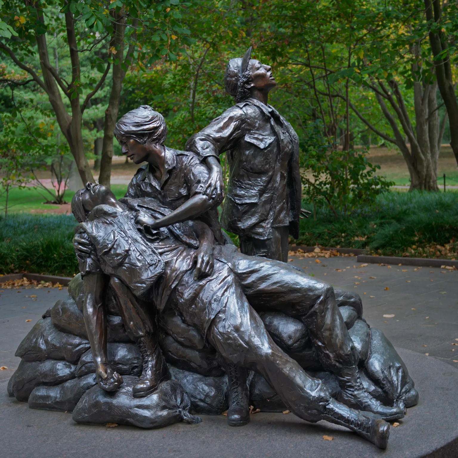 Photograph of the Vietnam Women's Memorial in Washington, D.C. which features a bronze sculpture depicting two women caring for a wounded soldier.