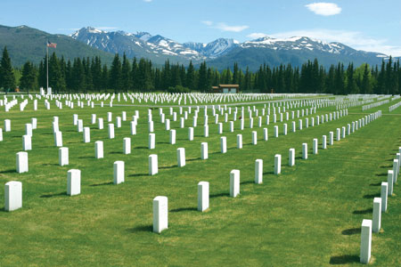 Snow-capped mountains rise above Fort Richardson National Cemetery.