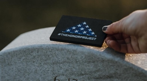 Hand-crafted commemorative token being placed on top of the headstone of a fallen hero.