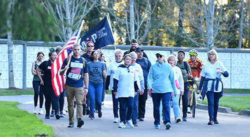 Carry The Load participants honor and remember Veterans during Memorial May while walking in front of columbariums at Tahoma National Cemetery in Kent, Washington.