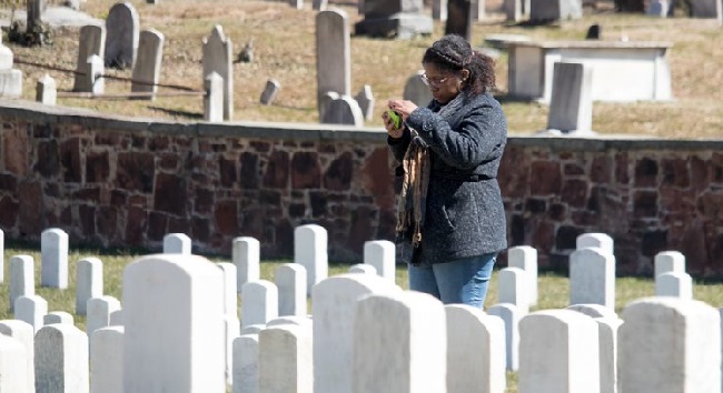 A student performs research at Alexandria National Cemetery in Virginia as part of the Veterans Legacy Program.