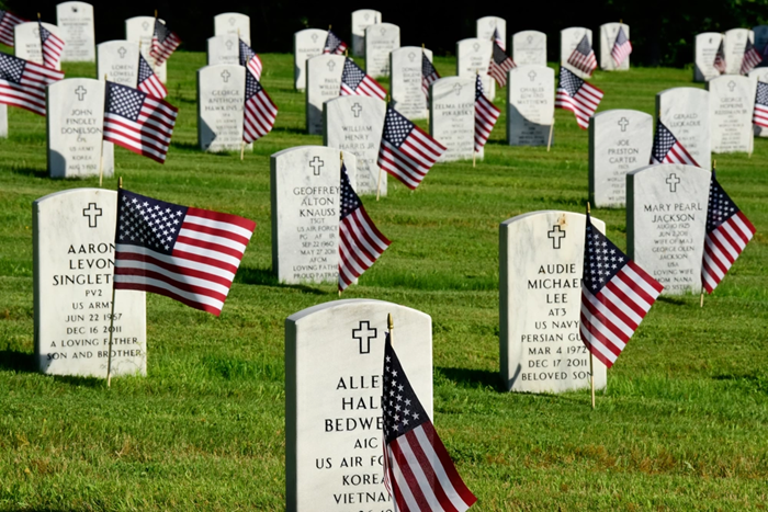 Flags placed in the ground in front of headstones at Arkansas Veterans State Cemetery at North Little Rock. (U.S. Army National Guard photo by Spc. Stephen Wright)