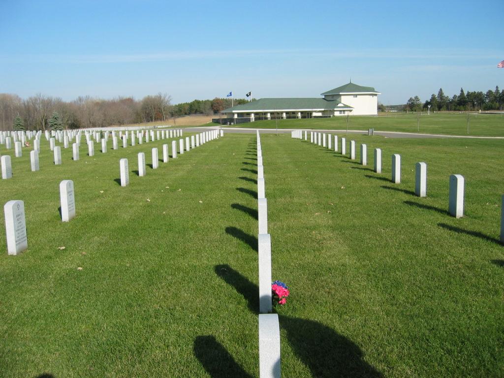 Picture of gravesites with upright headstones.